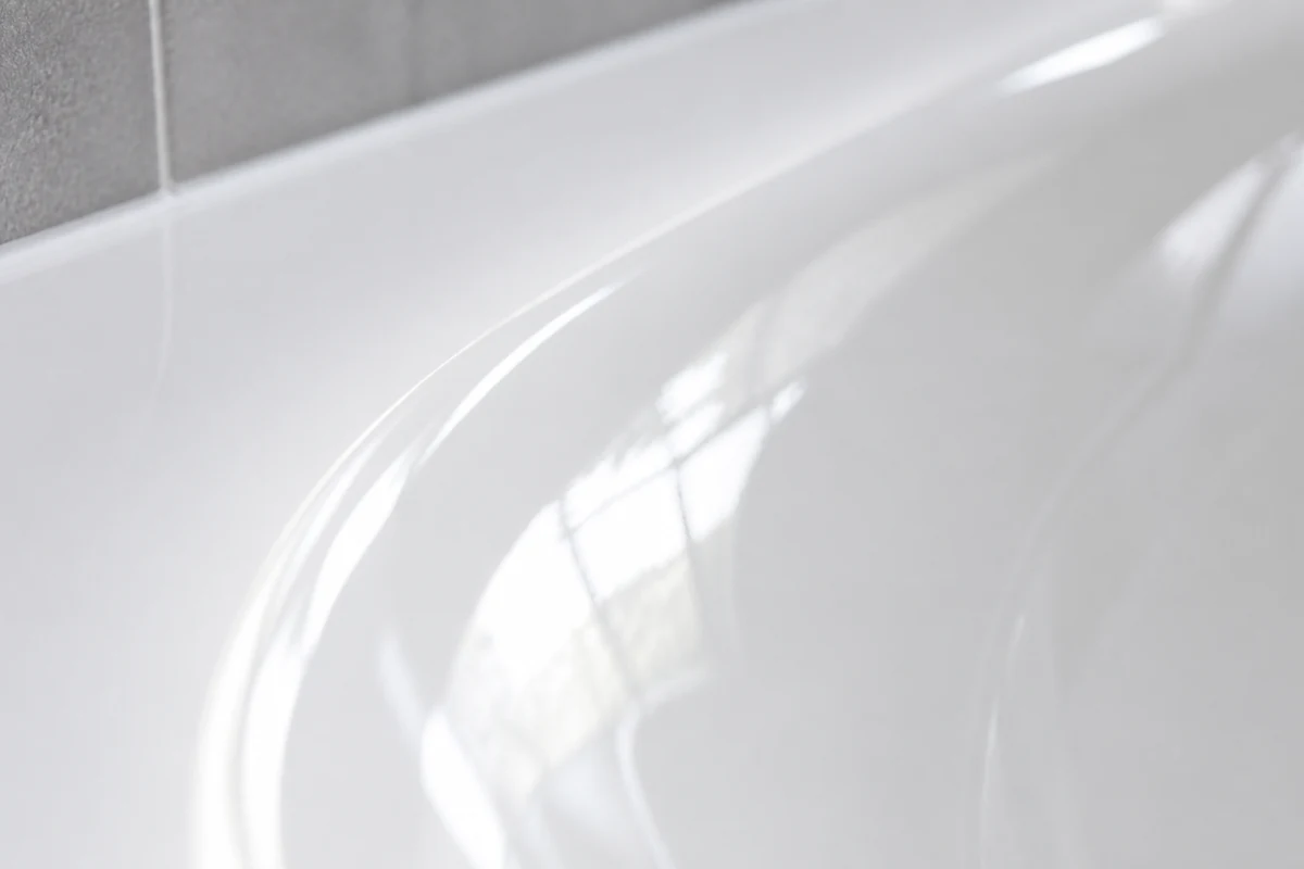 Close-up of a glossy reglazed white bathtub finish in a San Jose bathroom